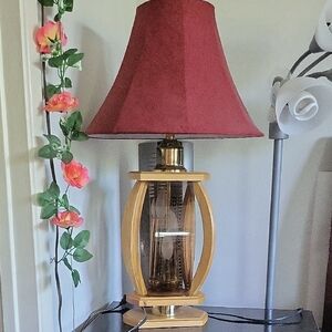 vintage-style table lamp features a bentwood frame and a decorative glass cylind